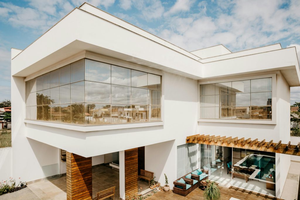 Modern white two-story house with glass walls